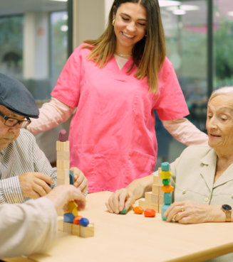 Friendly nurse talking to elder people in the nursing home